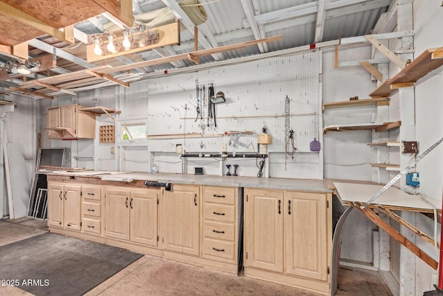 kitchen featuring open shelves, concrete flooring, light brown cabinets, and light countertops