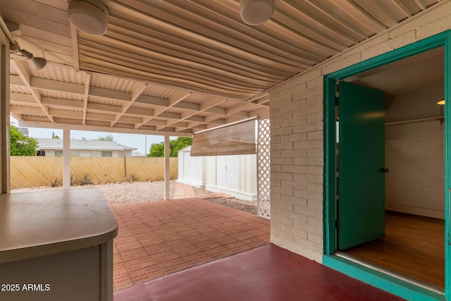 view of patio / terrace featuring fence, a storage shed, a ceiling fan, and an outdoor structure
