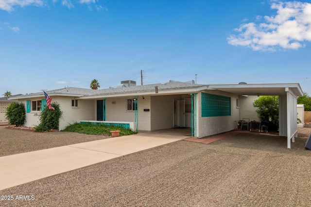 ranch-style house with an attached carport and driveway