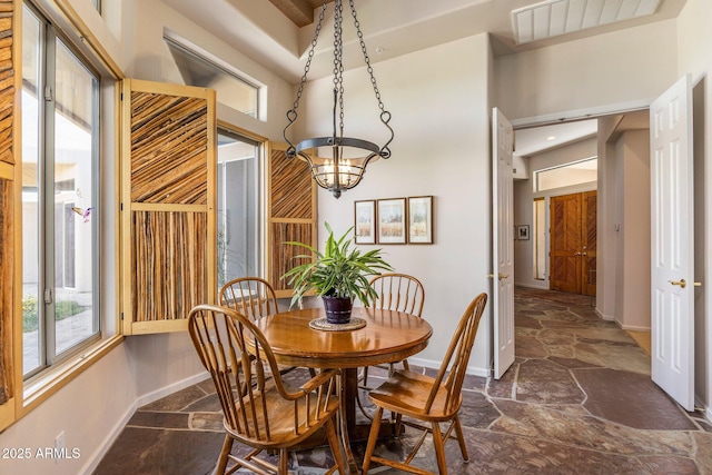 23760 N 80th Way, Scottsdale, AZ 85255 - dining space with stone flooring, baseboards, and a chandelier
