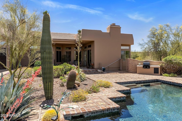 23760 N 80th Way, Scottsdale, AZ 85255 - back of house featuring exterior kitchen, a patio area, an outdoor pool, and stucco siding