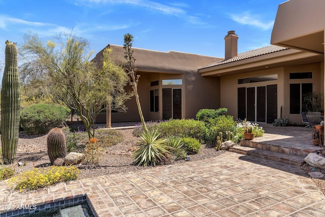 23760 N 80th Way, Scottsdale, AZ 85255 - back of property with a chimney, stucco siding, a patio area, and a tiled roof