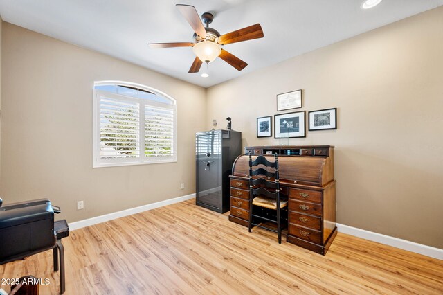 office space featuring a ceiling fan, baseboards, recessed lighting, and wood finished floors