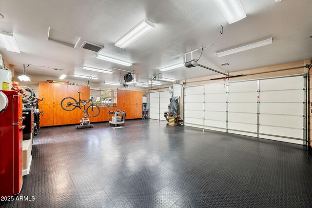 garage with visible vents and a garage door opener