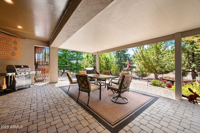 view of patio / terrace featuring outdoor dining area, fence, and grilling area