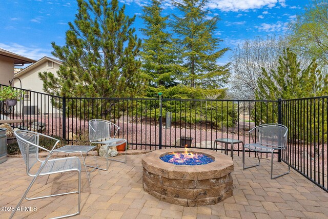 view of patio / terrace featuring a fire pit and fence