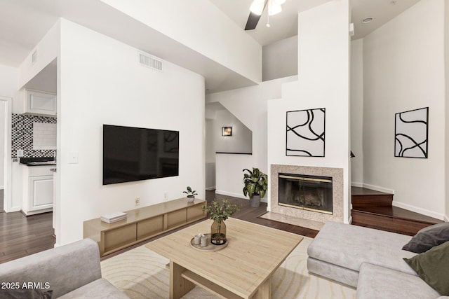 3633 N 3rd Ave Unit 2031, Phoenix, AZ 85013 - living room featuring ceiling fan, dark wood finished floors, a fireplace, and a towering ceiling
