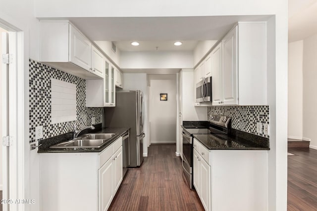 3633 N 3rd Ave Unit 2031, Phoenix, AZ 85013 - kitchen featuring stainless steel appliances, white cabinets, recessed lighting, backsplash, and dark wood-style floors