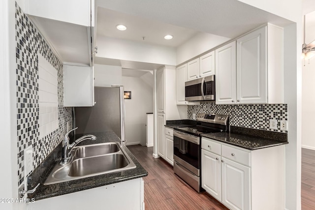 3633 N 3rd Ave Unit 2031, Phoenix, AZ 85013 - kitchen featuring appliances with stainless steel finishes, dark countertops, white cabinetry, backsplash, and recessed lighting