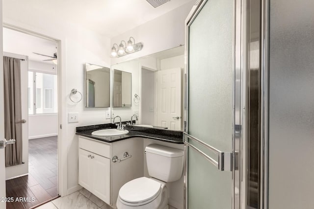 3633 N 3rd Ave Unit 2031, Phoenix, AZ 85013 - bathroom with vanity, a shower with shower door, and a ceiling fan
