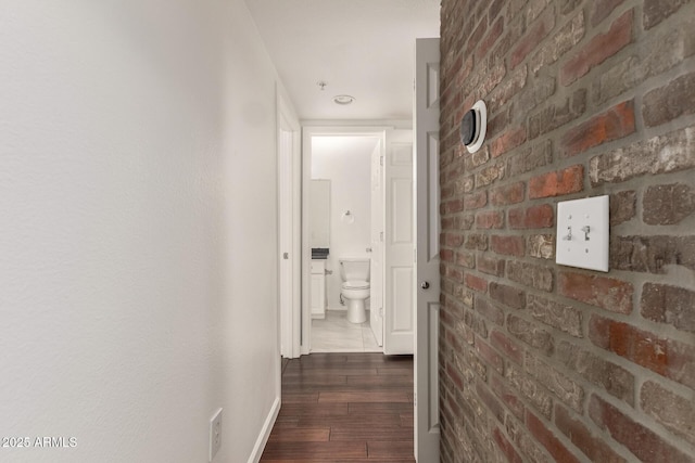 3633 N 3rd Ave Unit 2031, Phoenix, AZ 85013 - hall with dark wood-type flooring and brick wall