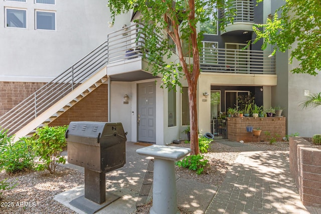 3633 N 3rd Ave Unit 2031, Phoenix, AZ 85013 - view of exterior entry featuring brick siding, stucco siding, and a balcony
