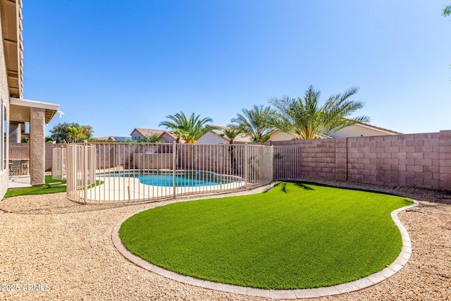 view of yard featuring a patio area, a fenced backyard, and a fenced in pool