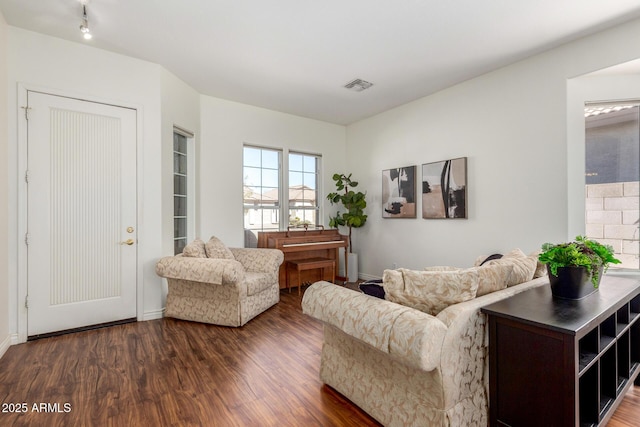 living room featuring visible vents and wood finished floors