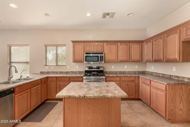 kitchen featuring appliances with stainless steel finishes, a sink, visible vents, and recessed lighting