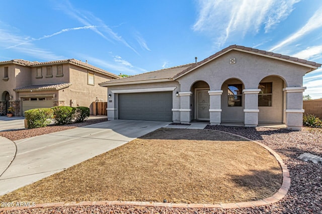 mediterranean / spanish-style house featuring a garage, driveway, and stucco siding