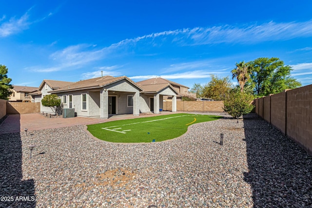 rear view of property with stucco siding, a patio area, a fenced backyard, and central air condition unit