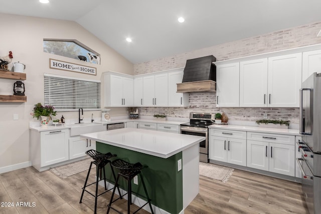 kitchen with white cabinets, stainless steel appliances, and custom exhaust hood