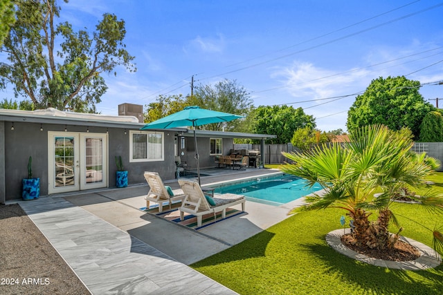 view of swimming pool featuring a patio area and a yard