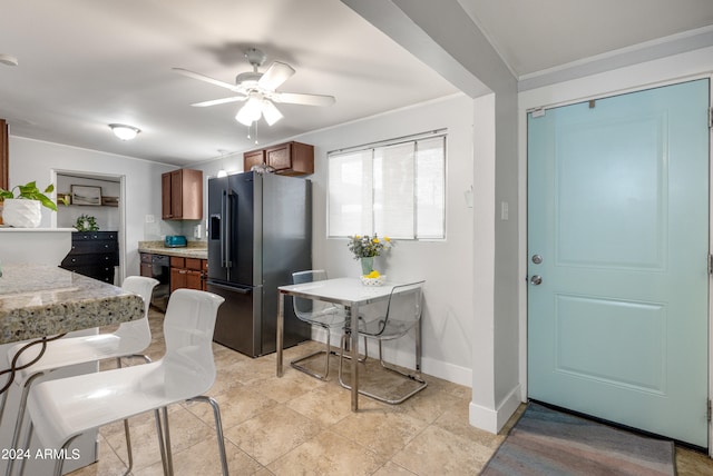 kitchen featuring dishwasher, ceiling fan, light tile patterned floors, and stainless steel fridge