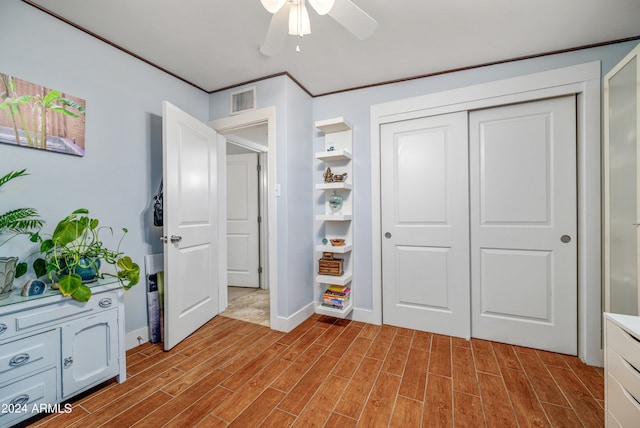 bedroom featuring ceiling fan, light wood-type flooring, and a closet