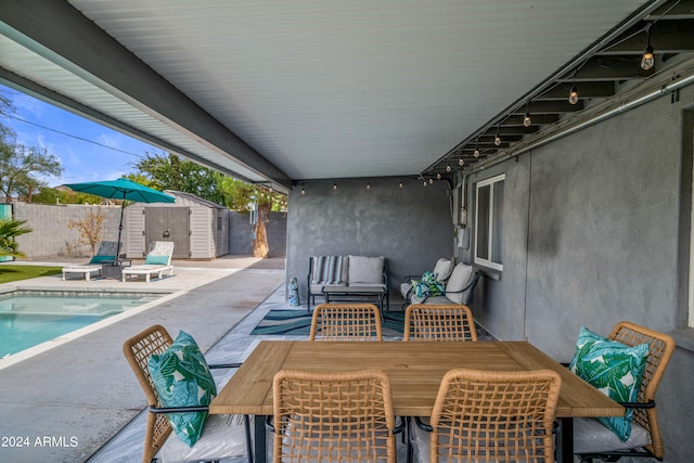 view of patio featuring a shed, a fenced in pool, and an outdoor hangout area