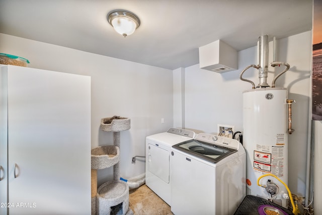 clothes washing area featuring water heater and separate washer and dryer