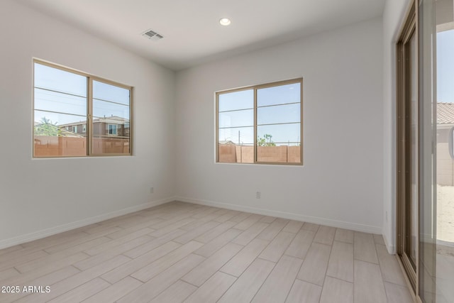 21640 E Roundup Way, Queen Creek, AZ 85142 - unfurnished room featuring plenty of natural light, recessed lighting, baseboards, and light wood finished floors