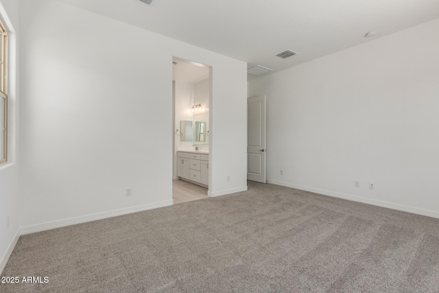 21640 E Roundup Way, Queen Creek, AZ 85142 - unfurnished bedroom with light carpet, baseboards, and connected bathroom