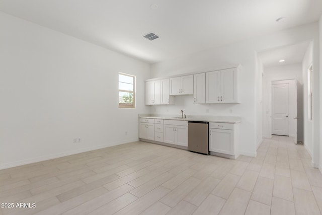 21640 E Roundup Way, Queen Creek, AZ 85142 - kitchen with a sink, dishwashing machine, light countertops, white cabinets, and baseboards