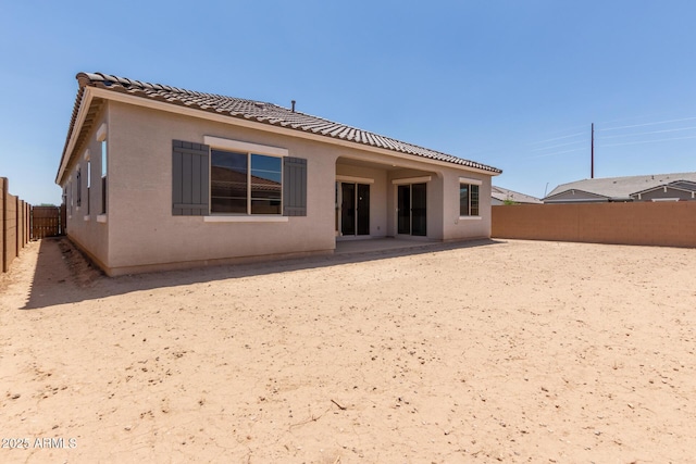21640 E Roundup Way, Queen Creek, AZ 85142 - rear view of property featuring a fenced backyard, a tiled roof, and stucco siding