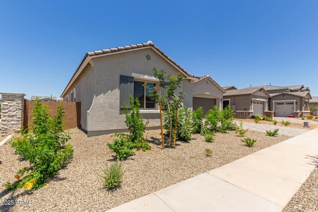 21640 E Roundup Way, Queen Creek, AZ 85142 - view of front facade featuring an attached garage, stucco siding, concrete driveway, and a tile roof