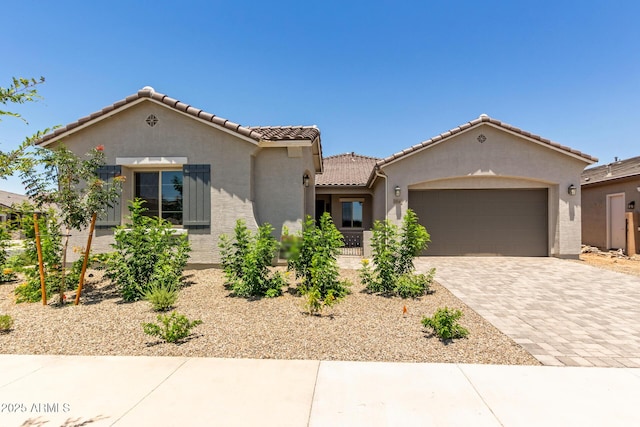 21640 E Roundup Way, Queen Creek, AZ 85142 - mediterranean / spanish home featuring stucco siding, a garage, a tile roof, and decorative driveway