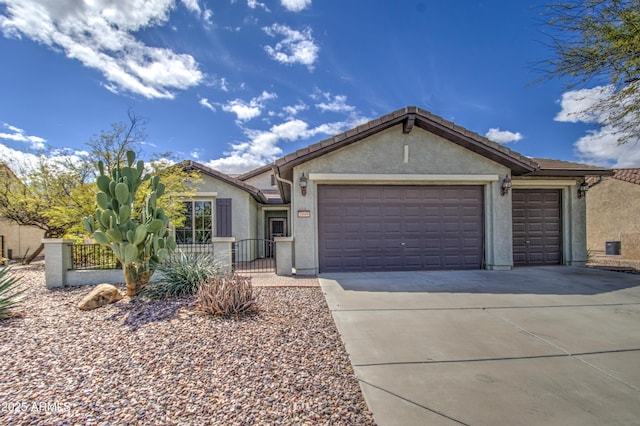 single story home featuring a fenced front yard, stucco siding, an attached garage, and driveway