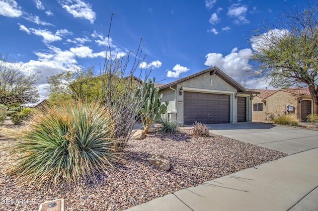 view of front of property featuring stucco siding, a garage, driveway, and a tiled roof