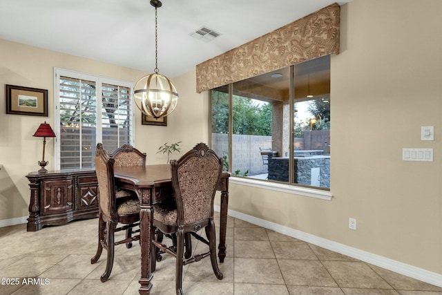 dining area with light tile patterned floors, plenty of natural light, and a notable chandelier