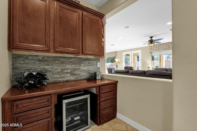 bar with french doors, tasteful backsplash, ceiling fan, and light tile patterned flooring