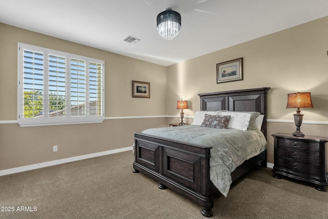 carpeted bedroom with an inviting chandelier