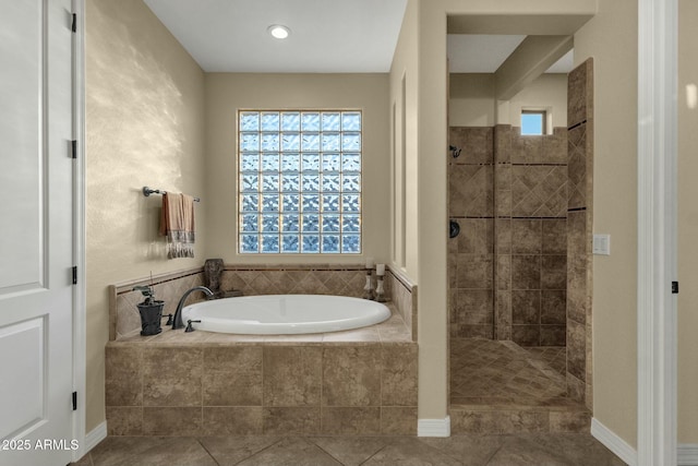 bathroom featuring tile patterned floors and separate shower and tub