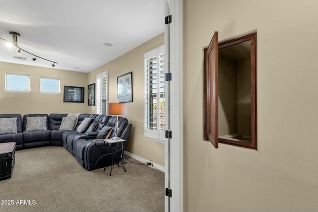 living room featuring light colored carpet and track lighting