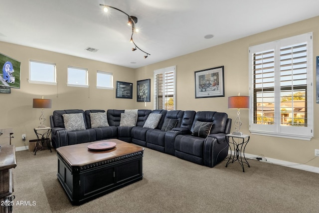 living room featuring carpet flooring and plenty of natural light