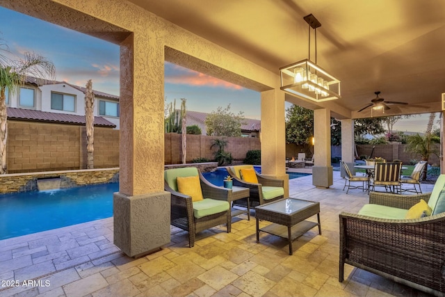 patio terrace at dusk with an outdoor living space, pool water feature, a fenced in pool, and ceiling fan