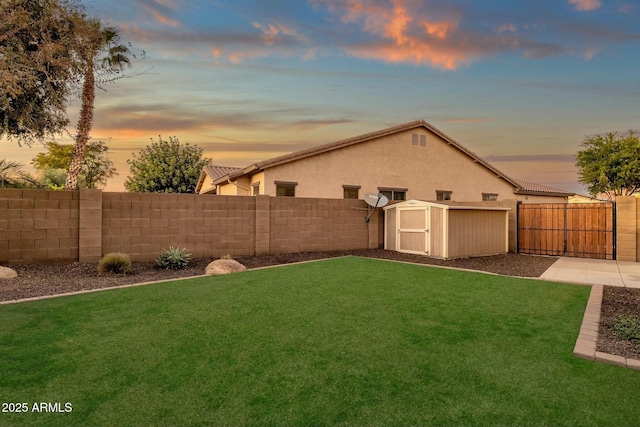 yard at dusk with a storage shed