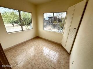 531 W Ocotillo Ave, Ajo, AZ 85321 - unfurnished bedroom with baseboards and light tile patterned floors