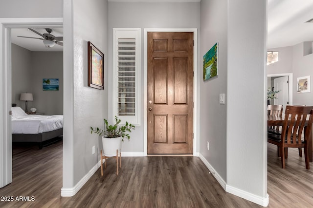 foyer with wood finished floors, visible vents, and baseboards