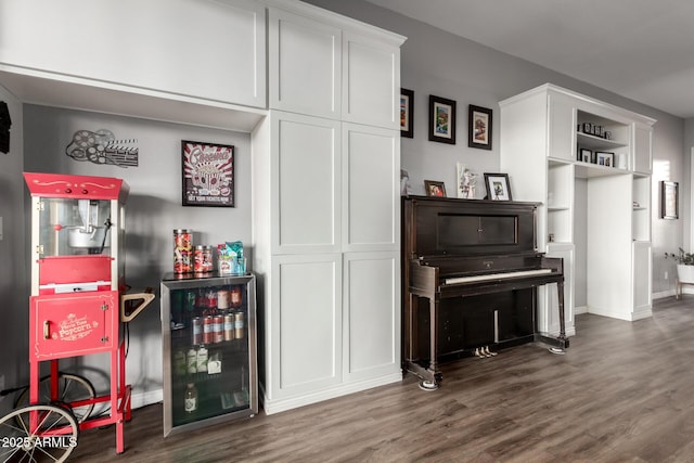 bar featuring wine cooler and dark wood-style flooring