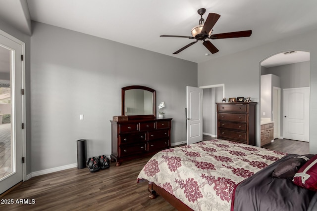 bedroom featuring baseboards, visible vents, arched walkways, a ceiling fan, and dark wood-style floors