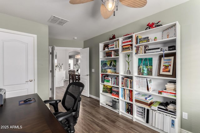 home office with arched walkways, wood finished floors, visible vents, baseboards, and a ceiling fan