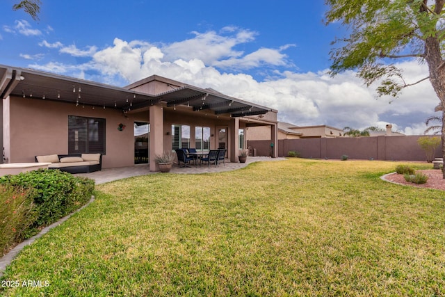 exterior space featuring a patio, an outdoor hangout area, fence, a lawn, and stucco siding