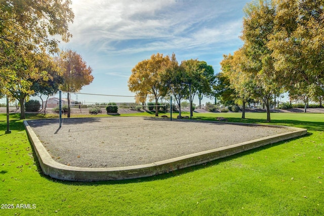 view of community with a lawn and volleyball court